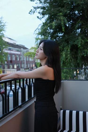 Environmental portrait at a railing at dusk