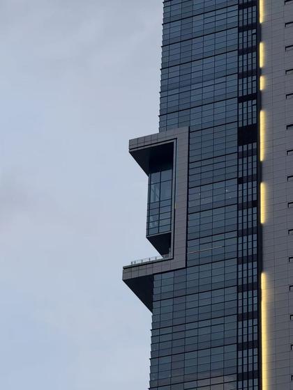 Glass tower corner against sky